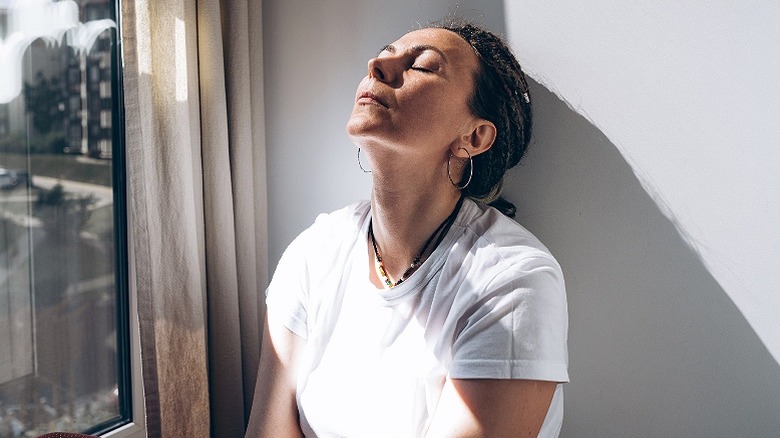 Person seated by sunny window