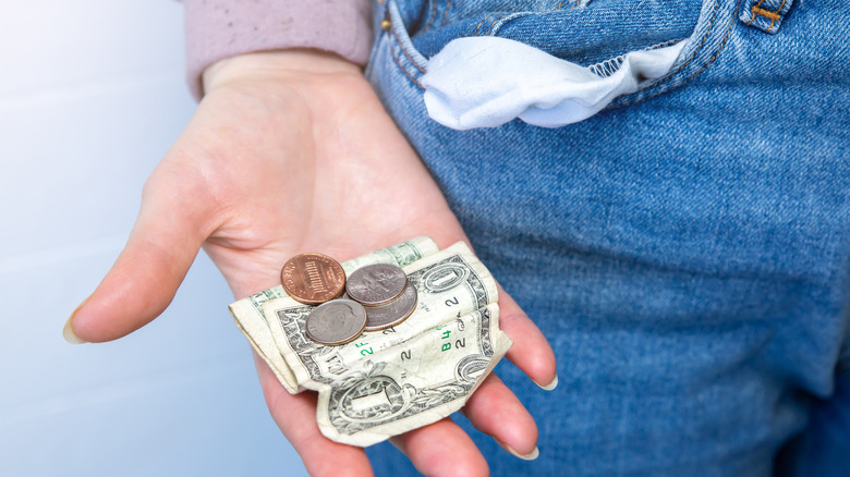 Person pulling change out of their pocket