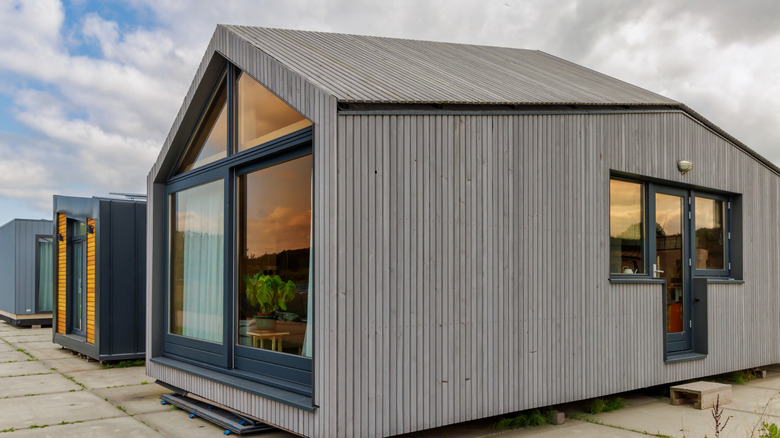 A modern tiny home on a concrete slab.