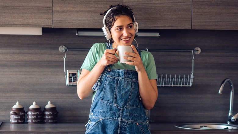 Person wearing earphones in kitchen
