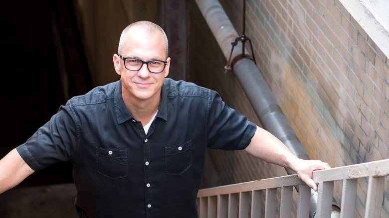 Roger Whitney standing on stairs