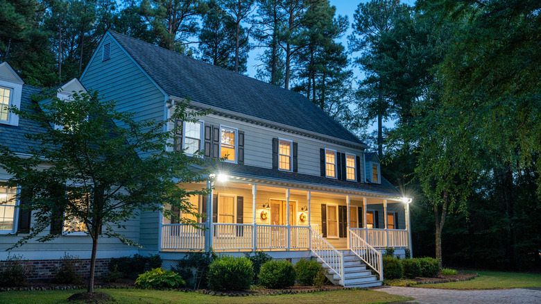 Illuminated Colonial style house at dusk