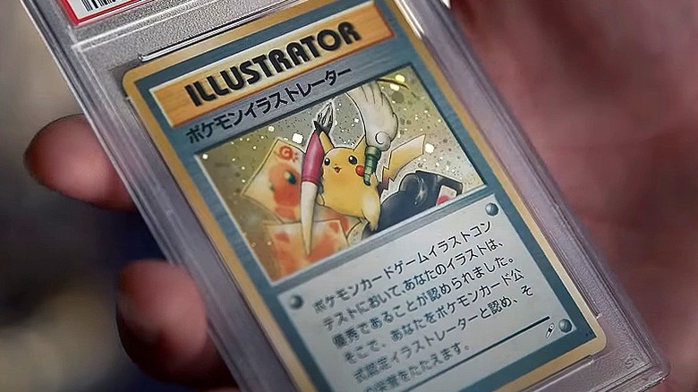 Hand holds Pikachu card
