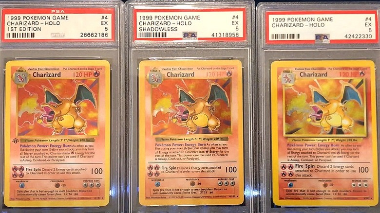 Three variants of Charizard card