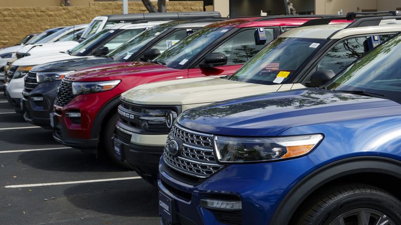 A row of different SUVs in a parking lot.