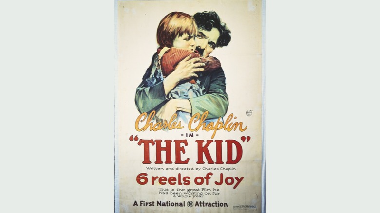 Charlie Chaplin "The Kid" poster with an illustration of him hugging a boy
