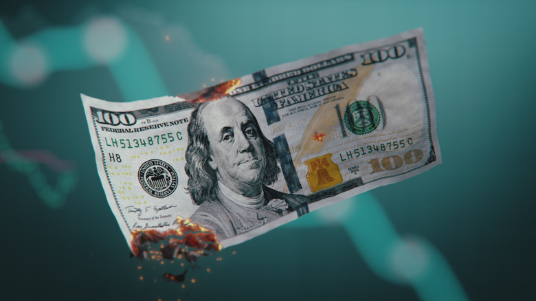 $100 bill singed at its edges