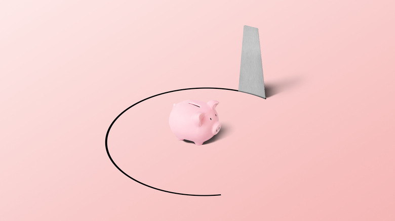 saw cutting a circle around a piggy bank