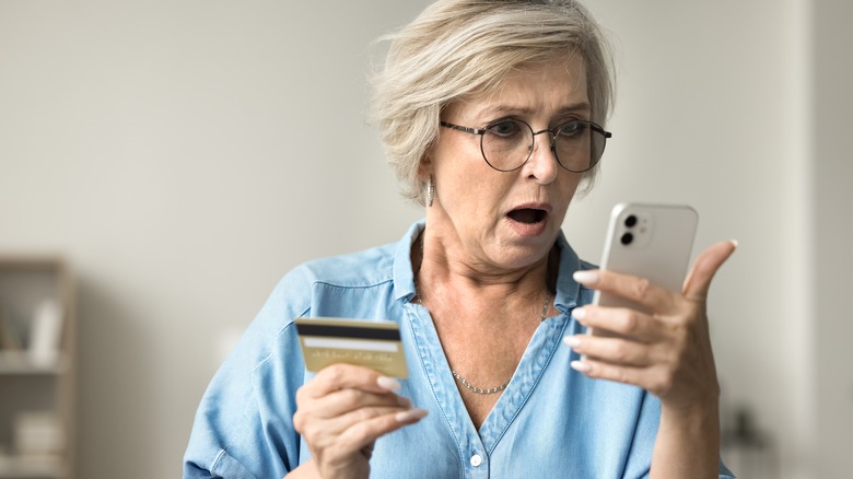 senior shocked at credit card statement on phone