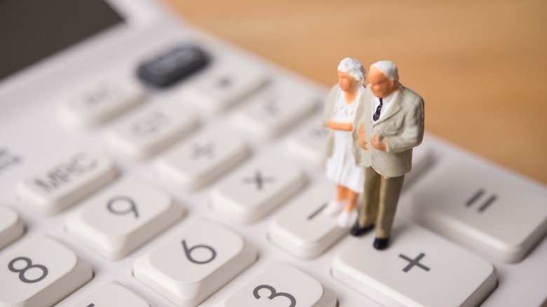retires people figurines on a calculator