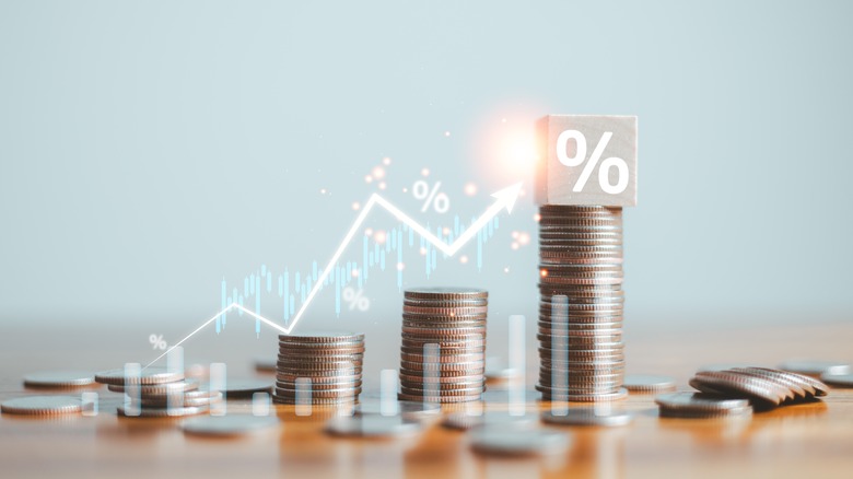 coin stacks growing with stock market lines