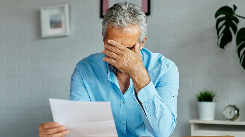 Senior checking his bills.
