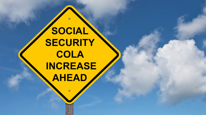 COLA increase sign with sky in background