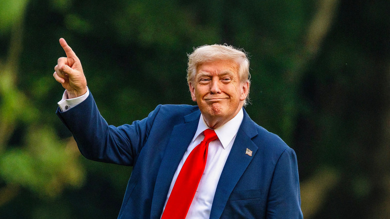 President Donald Trump gestures on the White House grounds