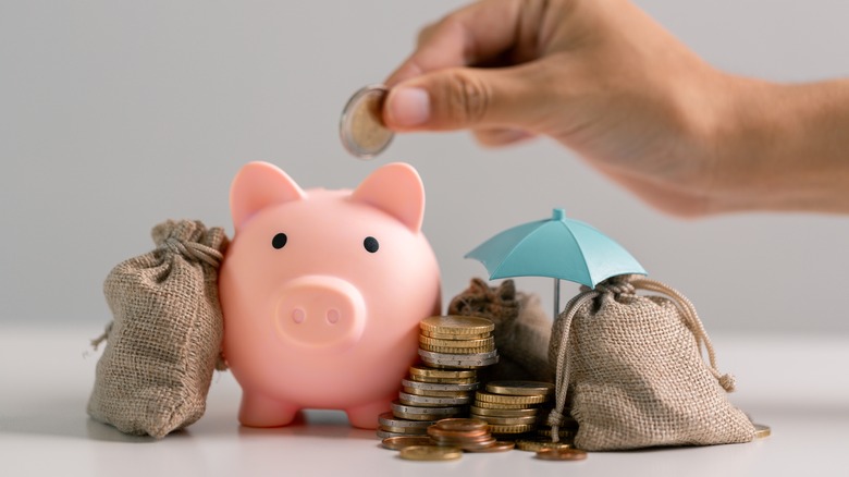 putting coins in piggy bank