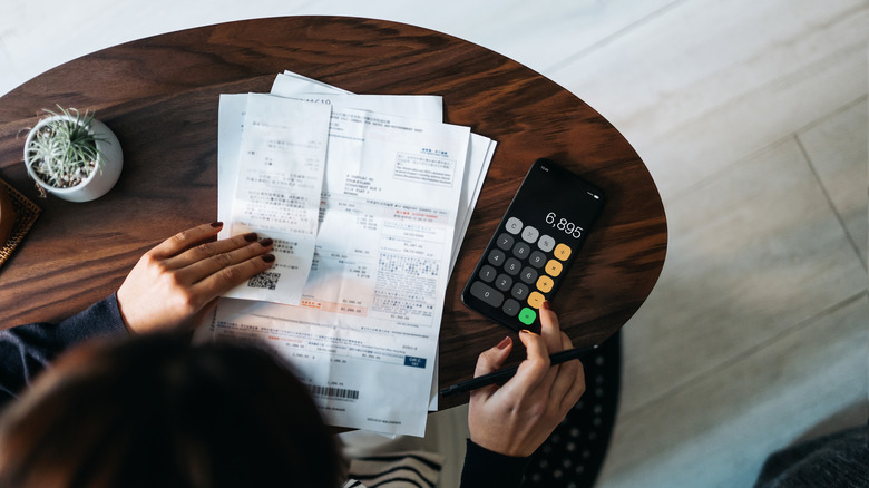 overhead view of someone calculating expenses