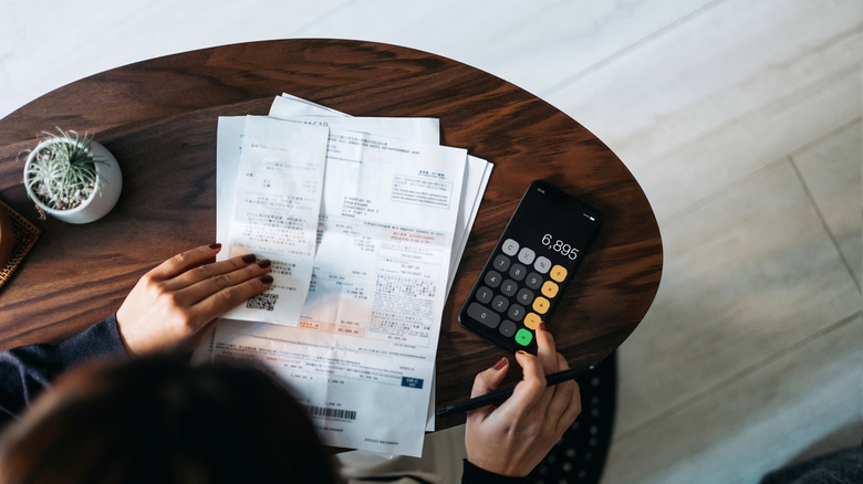 overhead view of someone calculating expenses