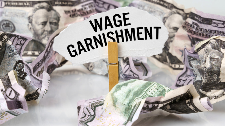 wage garnishment note surrounded by crumpled bills