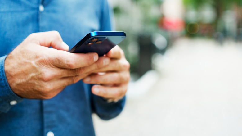 man holding phone in hands