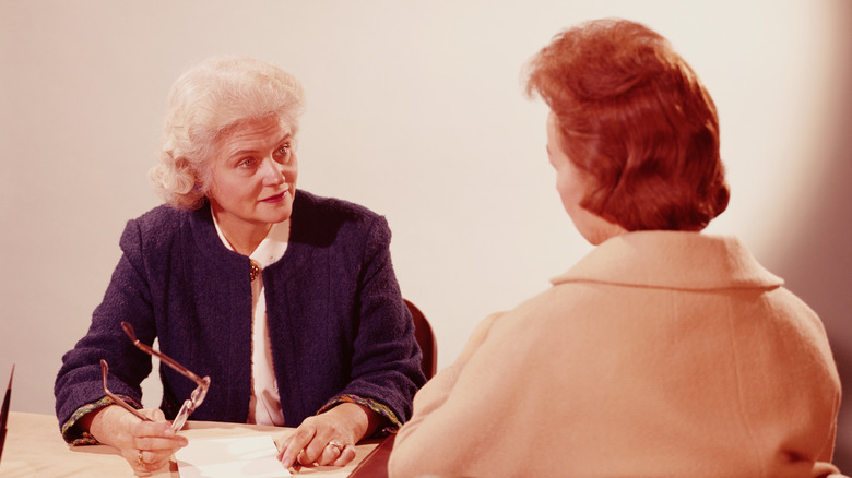 Vintage photo of two older women having a discussion