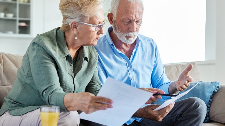 Older couple look over papers together