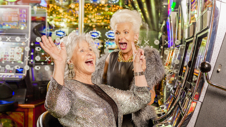 Pair of women excited in front of slot machines