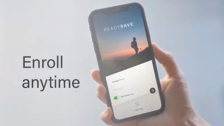 Hand holding smartphone with ReadySave app on screen