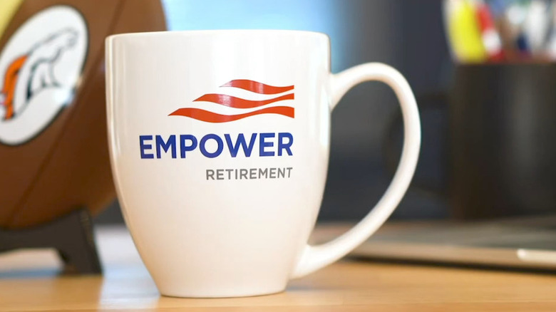 Close up of coffee mug with the Empower retirement logo written on it