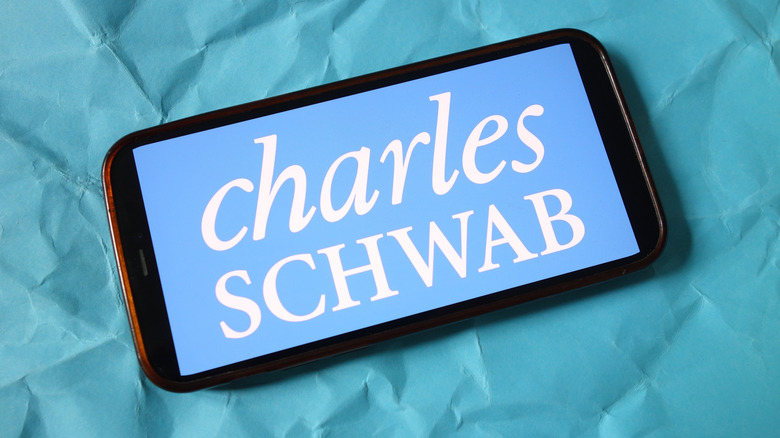 Top down shot of a smartphone with Charles Schwab logo on screen
