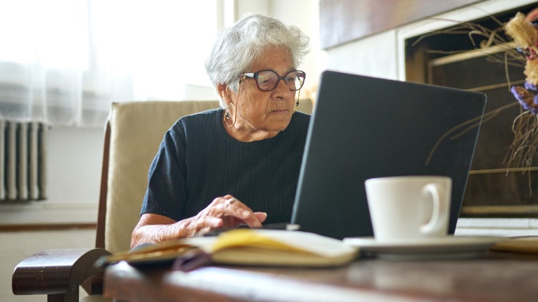 Senior women working on a laptop on a desk
