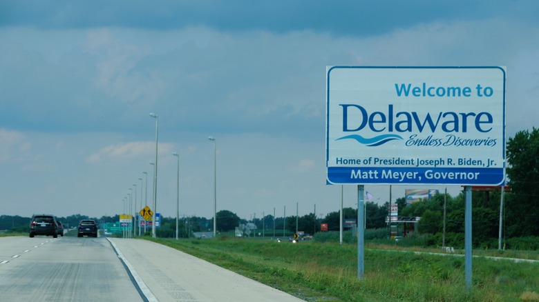 Road sign reading "Welcome To Delaware" next to highway