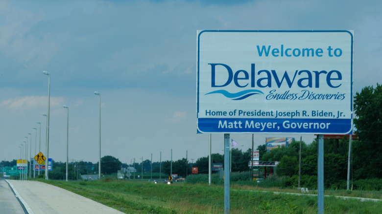 Road sign reading "Welcome To Delaware" next to highway