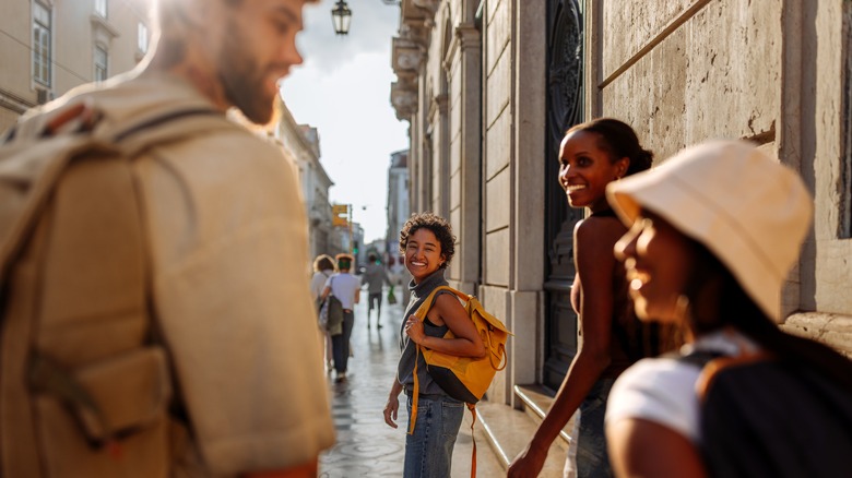 Group of young friends walking down a European street
