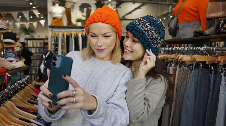 Two female friends taking a selfie while shopping