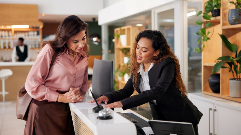 Front desk employee assisting guest with check-in