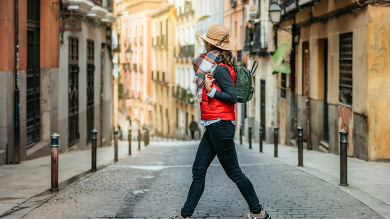 woman traveler crossing street in Madrid