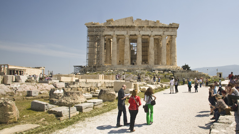 Tourists exploring an archeological site in Greece.