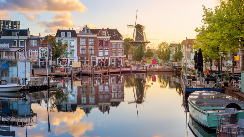 A view of the Beestenmarkt and the De Valk mill reflecting in Rhine river on sunrise, South Holland, Netherlands.