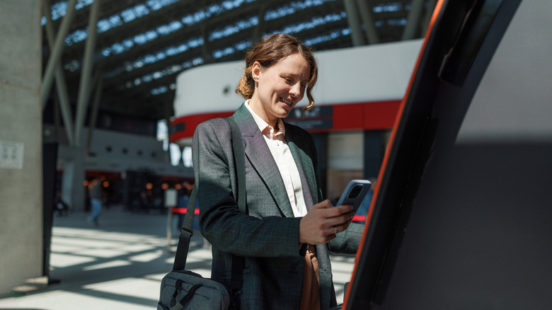 traveler standing at airport ATM