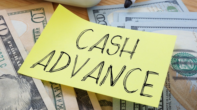 cash advance on sticky note over money