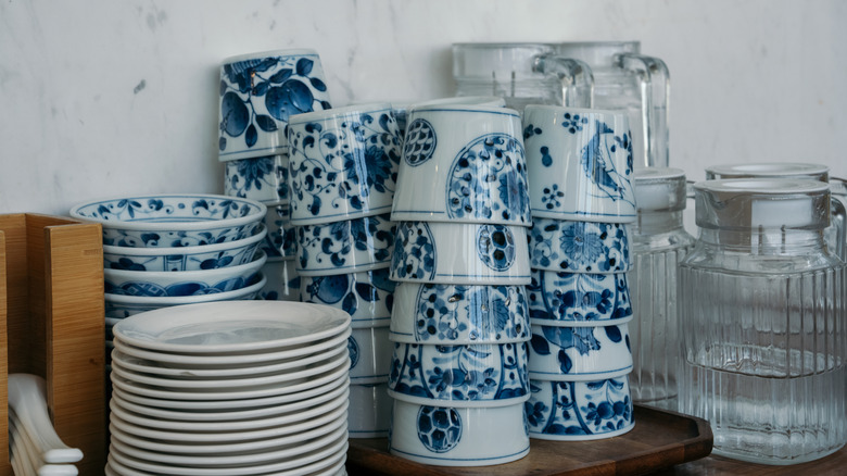 Stacks of blue and/or white dishes, bowls, and cups