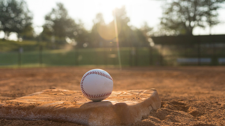 A baseball sitting outside on a baseball diamond