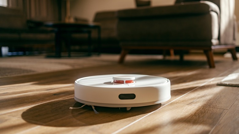 picture of a white, disc-shaped robot vacuum