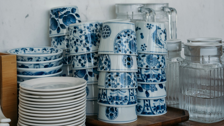 Stacks of blue and/or white dishes, bowls, and cups