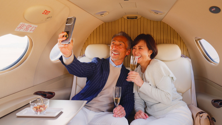A wealthy couple on a private jet