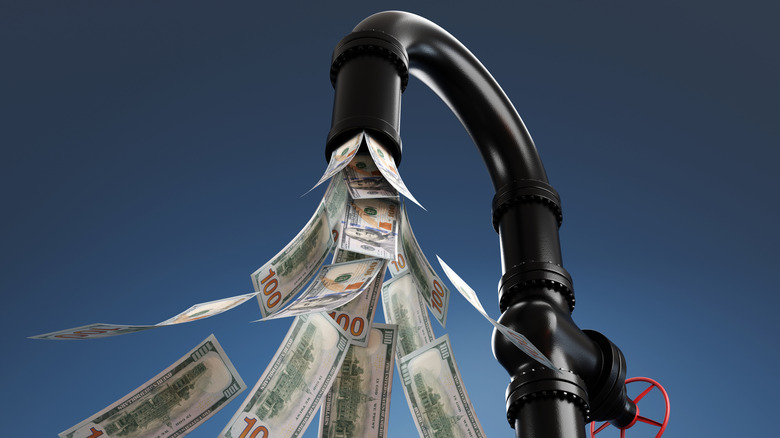 money pouring out of a faucet
