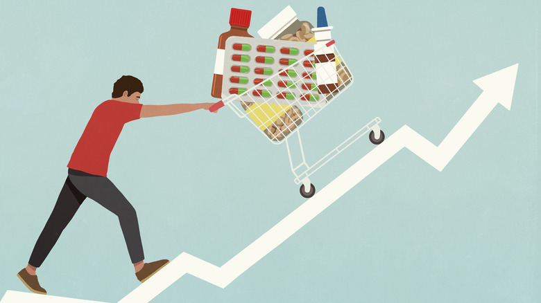 illustration of man pushing grocery cart full of medical supplies up a steep hill shaped like an arrow