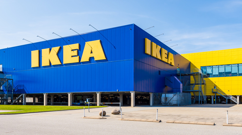 Large IKEA signs on the blue facade of the IKEA store, a swedish multinational company that markets flat-pack furniture.