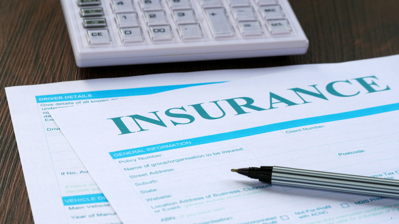 Close-up of an insurance claim document with a pen on top.