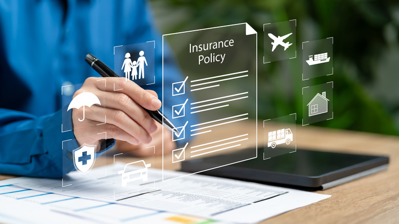Woman placing pen on virtual document of an insurance policy.